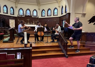 Teacher gestures at student trio