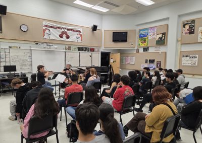 Professional musicians perform for students in classroom