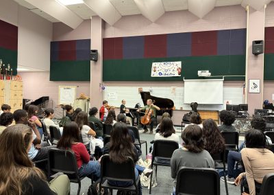 Professional musicians perform for students in classroom