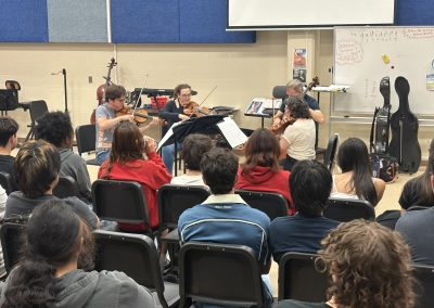 Professional musicians perform for students in classroom