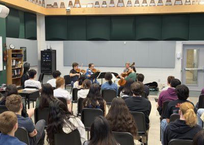 Professional musicians perform for students in classroom